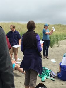 Rachel Stendahl, Chehalis Basin Education Consortium, and Aleks Storik, explain COASST protocol on the beach