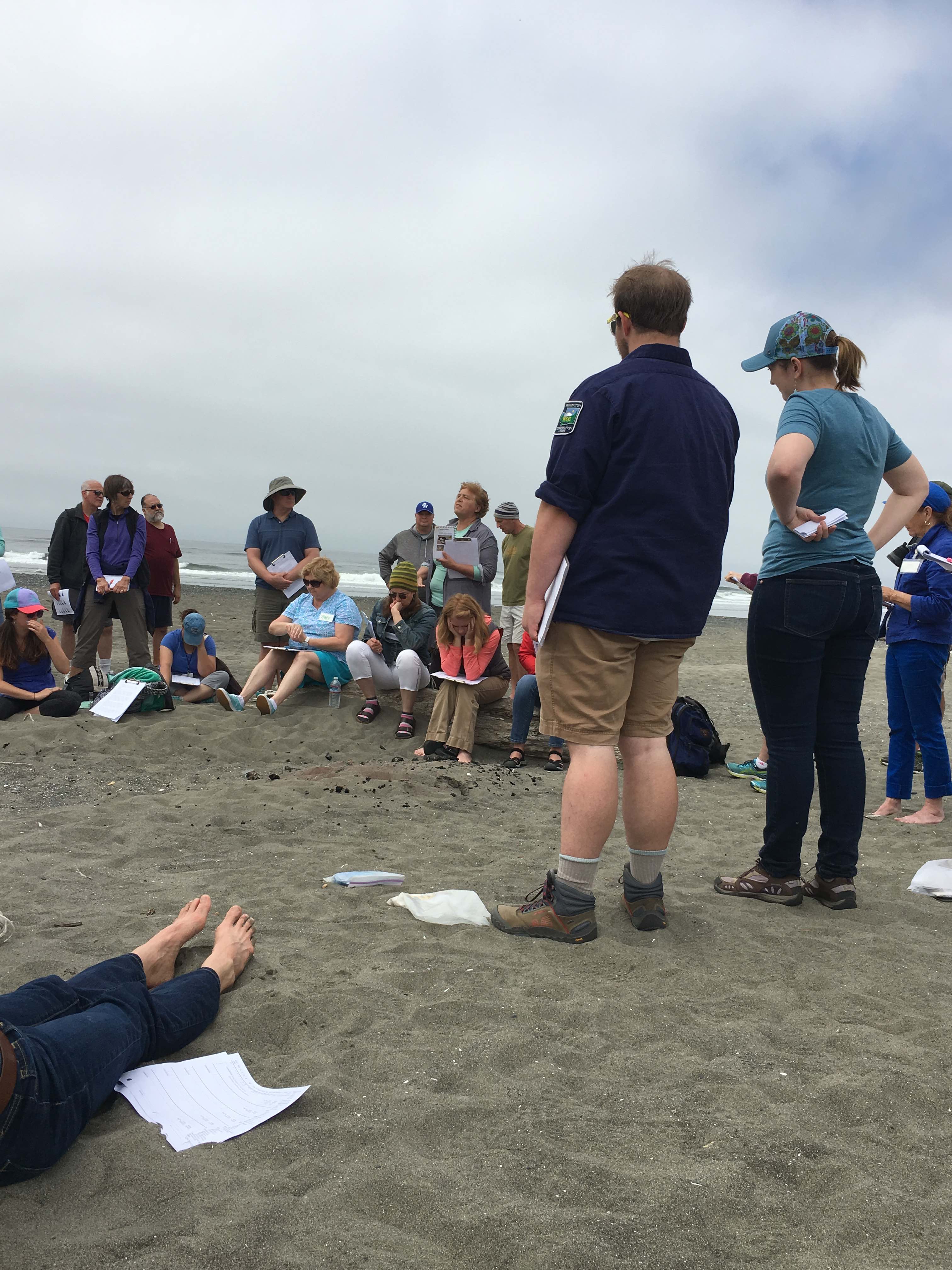 Rachel Stendahl, Chehalis Basin Education Consortium, and Aleks Storvik, WCC Americorps with Nisqually River Education Project, teaching some citizen science on the beach with UW's COASST protocol